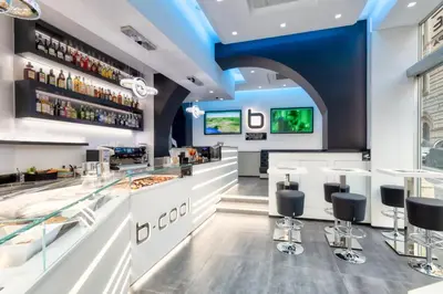 a restaurant with a bar with stools at THE ONE Boutique Hotel & SPA Roma in Rome