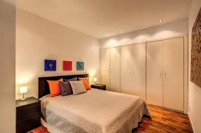 a bedroom with a bed and a large white cabinet at Lovely apartment close Vatican in Rome
