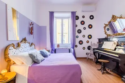a bedroom with a bed and a piano at Home Of Arts in the Center in Rome