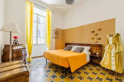 a bedroom with a bed with an orange blanket at Home Of Arts in the Center in Rome