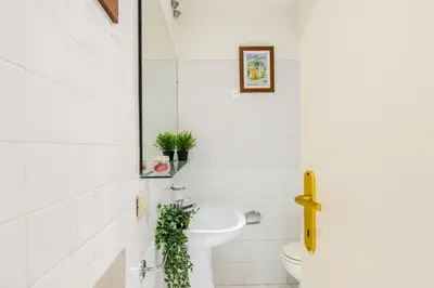 a bathroom with a sink and a toilet at Home Of Arts in the Center in Rome