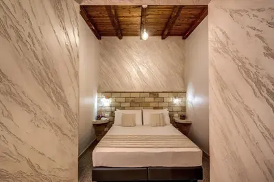 a bedroom with a large bed in a room at Colosseo Accomodation Room Guest House in Rome