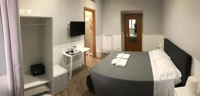a bedroom with a bed with towels on it at Rent Rooms Colosseum in Rome