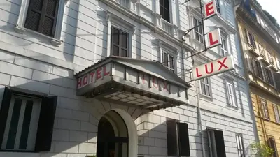 a building with a sign on the side of it at Raeli Hotel Lux in Rome