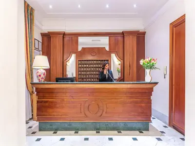 a woman talking on a phone in a courtroom at Raeli Hotel Lux in Rome