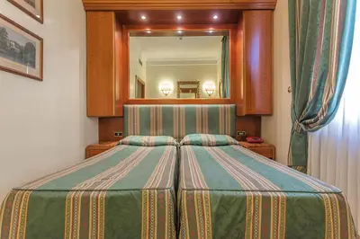 a bedroom with a large bed with a large mirror at Raeli Hotel Luce in Rome