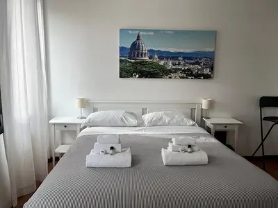a bedroom with a large bed with towels on it at Vista Cupola House in Rome