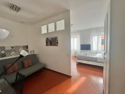 a living room with a couch and a bed at Vista Cupola House in Rome