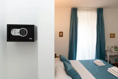 a bedroom with a bed with a tv on the wall at Art Atelier Borgo in Rome