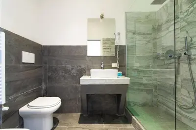 a bathroom with a toilet and a sink and a shower at Art Atelier Borgo in Rome