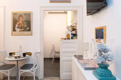 a room with a table with a vase on a counter at Art Atelier Borgo in Rome