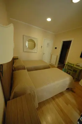 a hotel room with two beds and a table at Residenza Dei Gracchi in Rome
