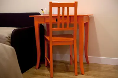 a wooden table with a chair next to a couch at Residenza Dei Gracchi in Rome