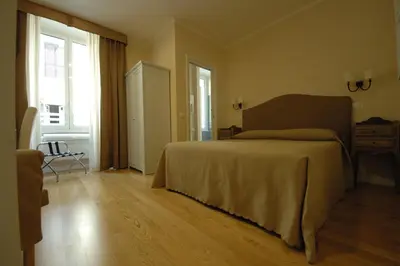 a bedroom with a large bed and a wooden floor at Residenza Dei Gracchi in Rome