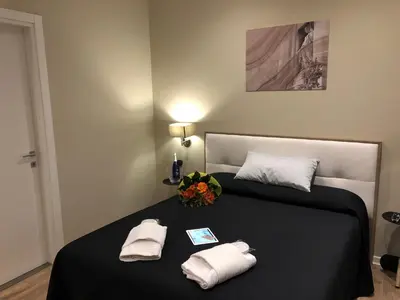 a bedroom with a bed with two towels on it at Trevi Portrait in Rome