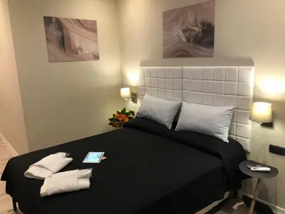 a bedroom with a bed with two towels on it at Trevi Portrait in Rome