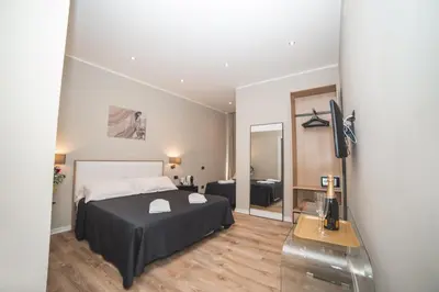 a bedroom with a bed and a television in a room at Trevi Portrait in Rome