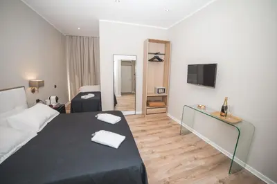 a hotel room with a bed and a television at Trevi Portrait in Rome