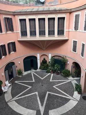 a courtyard with a star design on the side of a building at Trevi Portrait in Rome