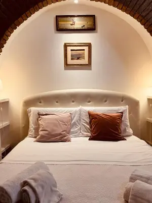 a bedroom with a white bed with two pillows at Loft In Rome Termini-Colosseum in Rome