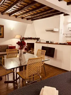 a living room with a glass table and chairs at Loft In Rome Termini-Colosseum in Rome