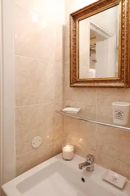 a bathroom with a sink and a mirror at Loft In Rome Termini-Colosseum in Rome