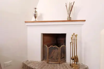 a fireplace with a white mantle with a wooden insert at Loft In Rome Termini-Colosseum in Rome
