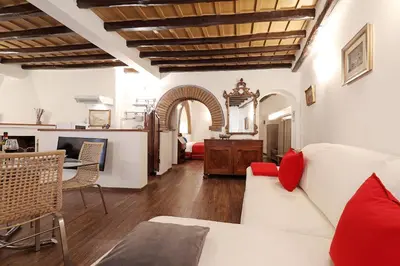 a living room with a white couch and red pillows at Loft In Rome Termini-Colosseum in Rome