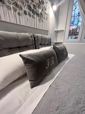 a bedroom with a large bed with pillows on it at Spagna Rooms in Rome
