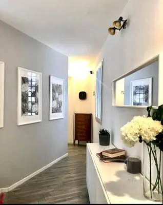 a living room with a vase of flowers on a counter at Spagna Rooms in Rome
