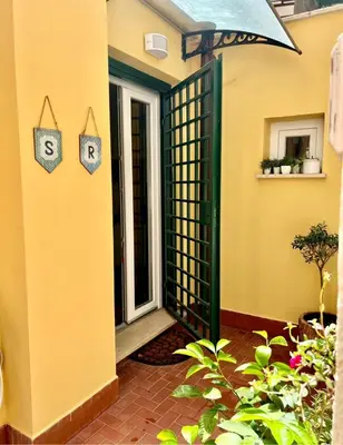 an entrance to a house with a gate and plants at Spagna Rooms in Rome