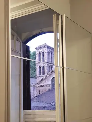 a view of a building through an open window at La Roma di Camilla in Trastevere in Rome