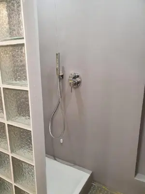 a shower with a hose attached to a wall at La Roma di Camilla in Trastevere in Rome