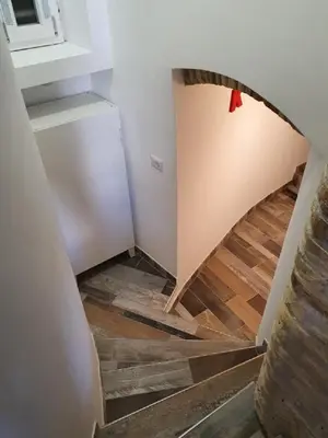 a room with a staircase with a refrigerator at La Roma di Camilla in Trastevere in Rome