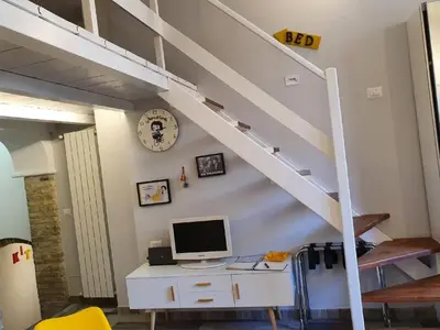 a computer on a desk under a staircase at La Roma di Camilla in Trastevere in Rome