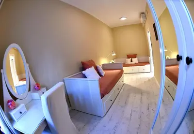 a small room with two beds and a mirror at Jubilee 3 Luxury apartment in Rome Vatican in Rome