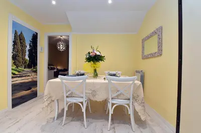 a dining room with a table and two chairs at Jubilee 3 Luxury apartment in Rome Vatican in Rome