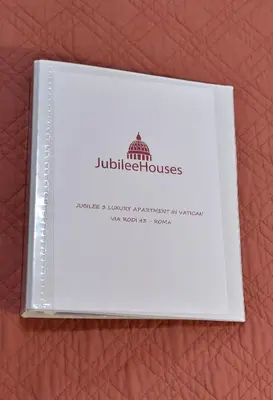 a book sitting on top of a brown wallet at Jubilee 3 Luxury apartment in Rome Vatican in Rome
