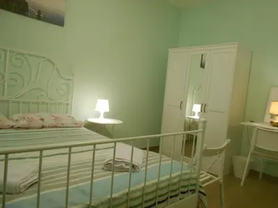 a small bedroom with a bed and a dresser at L'Oleandro di Alfredo in Rome