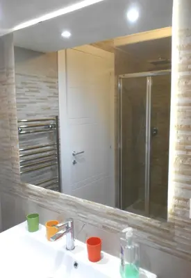 a bathroom mirror with a sink and a shower at L'Oleandro di Alfredo in Rome