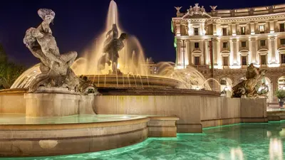 a fountain in front of a building at night at L'Oleandro di Alfredo in Rome
