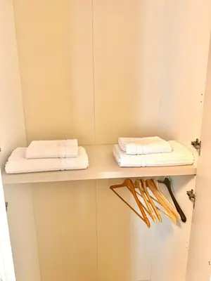 two towels are sitting on a shelf in a bathroom at Dodo Holiday in Rome in Rome