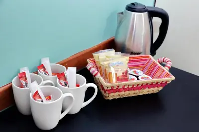 a table with three cups and a tea kettle at Dandi Domus in Rome