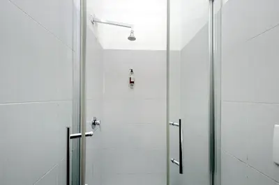 a shower with a glass door in a bathroom at Dandi Domus in Rome