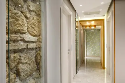 a hallway of a hotel with a stone wall at Magica Luna Boutique Hotel - Roma in Rome