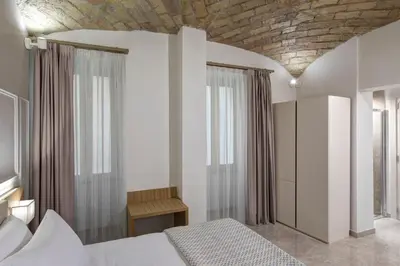 a bedroom with a bed and a brick ceiling at Magica Luna Boutique Hotel - Roma in Rome