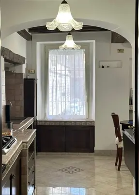 a large kitchen with a large window and a table at A Casa di Giulia in Rome
