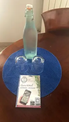 a bottle of water and a book on a table at A Casa di Giulia in Rome