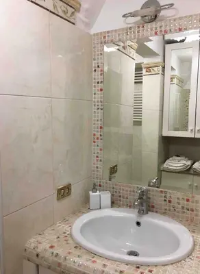 a bathroom with a sink and a mirror at A Casa di Giulia in Rome