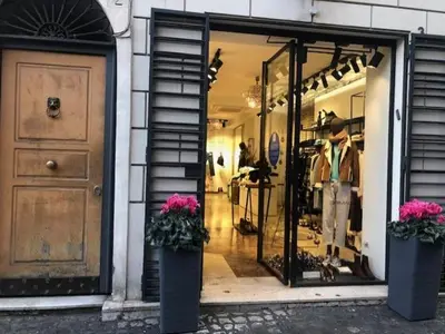 a store front with a door and flowers in front at A Casa di Giulia in Rome